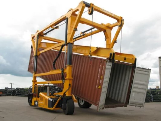 Combilift straddle carrier tilting a container