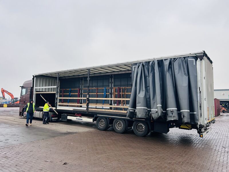 Open curtainside trailer being prepared for loading