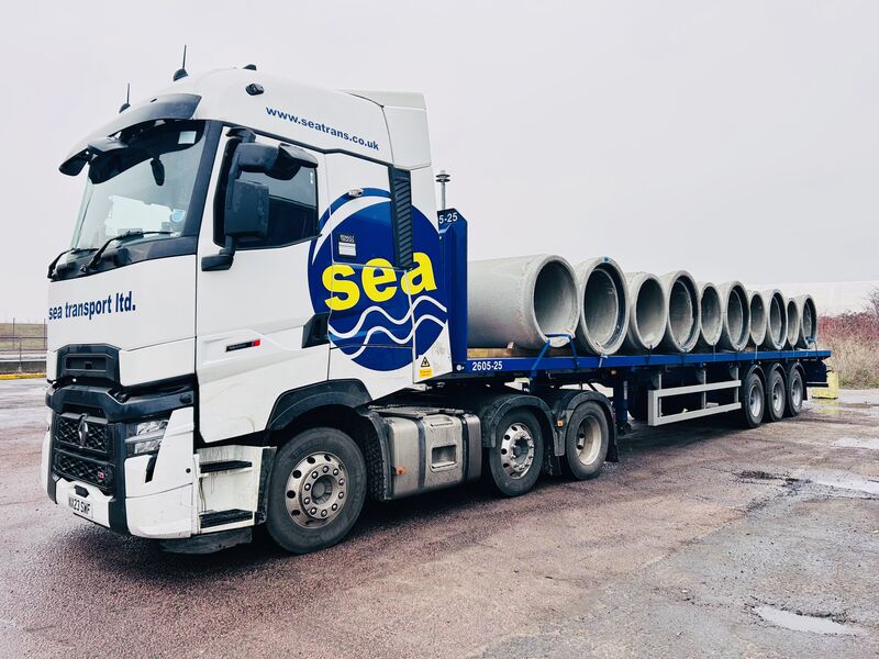 SEA Transport platform trailer carrying precast concrete pipes